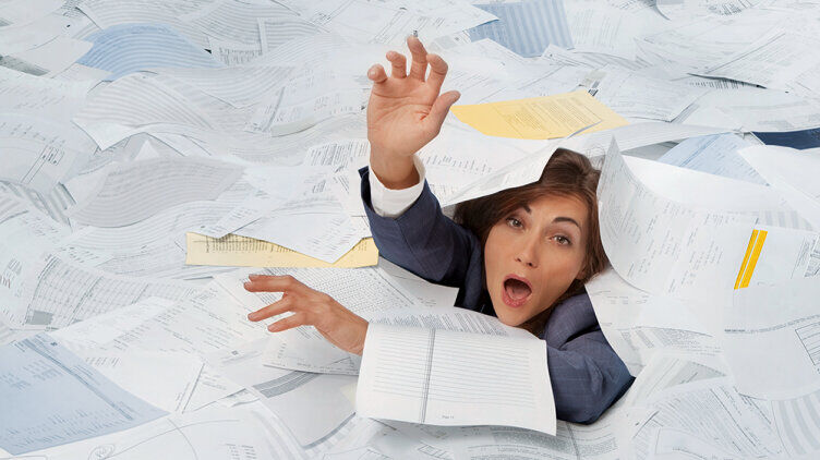 Woman submerged in documents