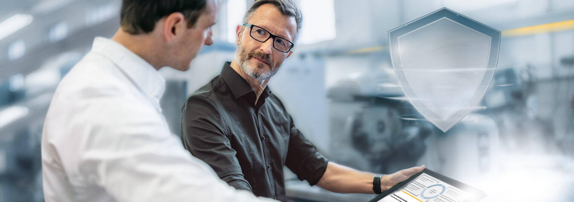 Two men looking at a tablet together